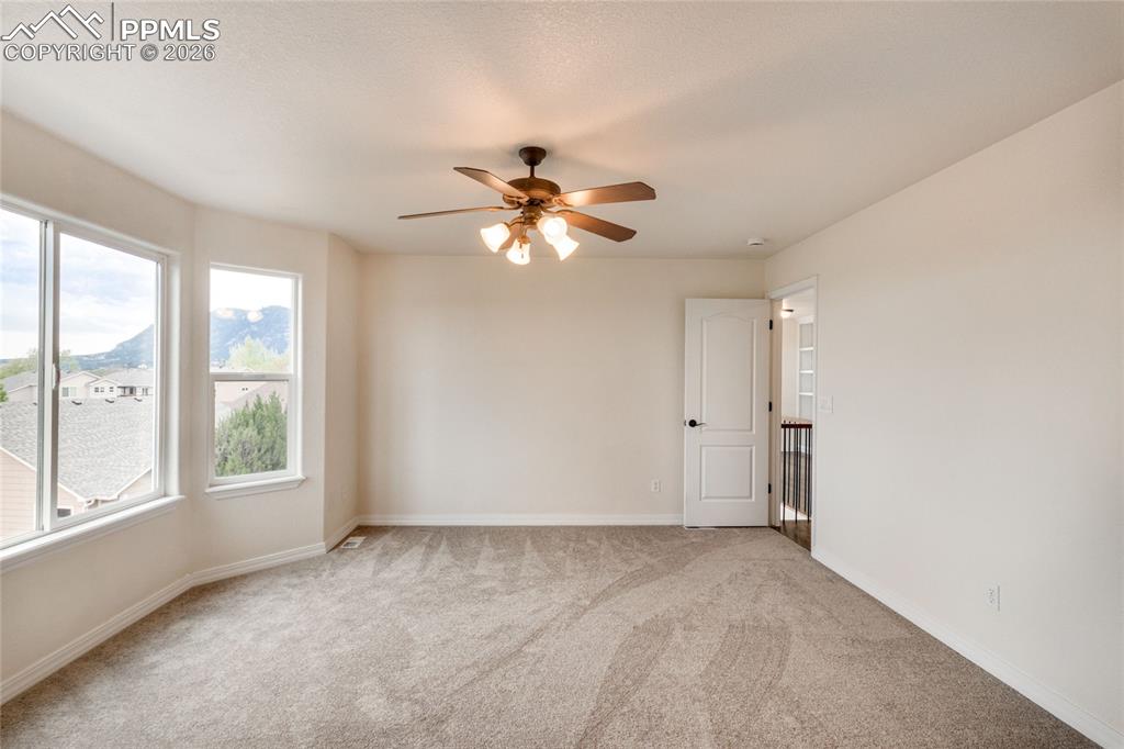 Image 19 of 35: Spacious primary bedroom with an abundance of natural light.