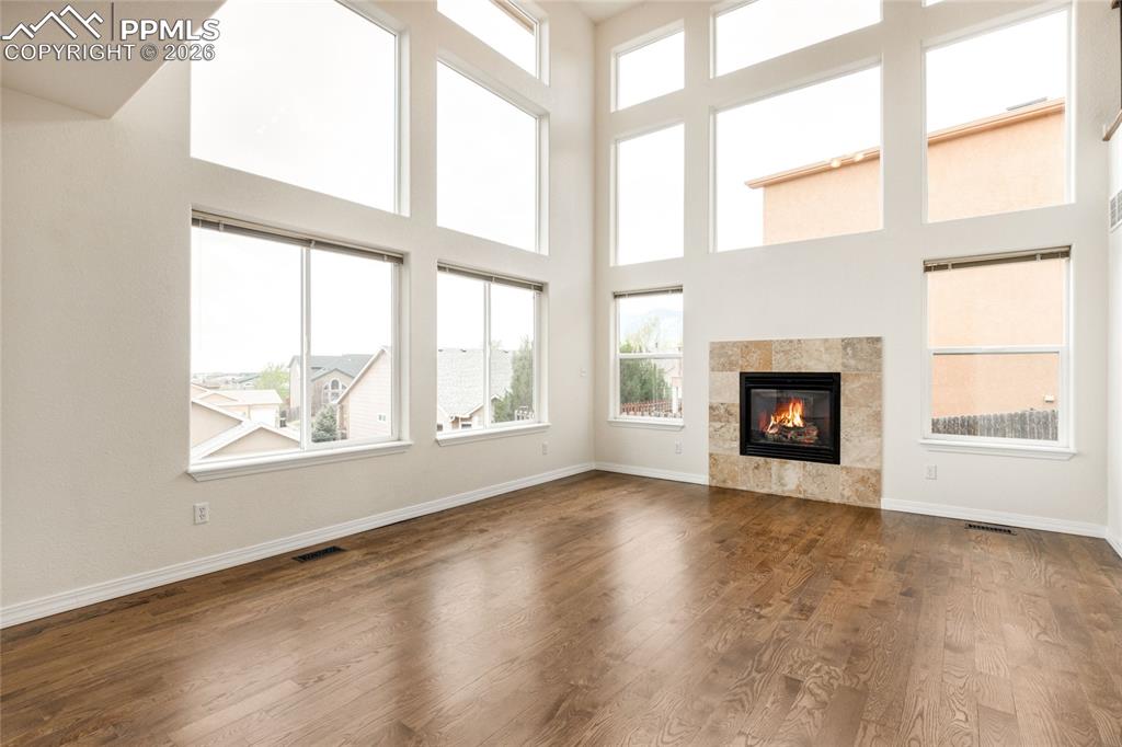 Image 2 of 35: Living area featuring soaring ceilings and extensive natural light through