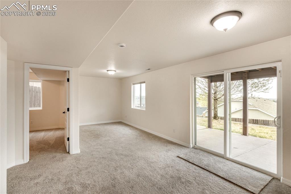 Image 27 of 35: Spacious bonus room featuring neutral carpeting, recessed lighting, and a w