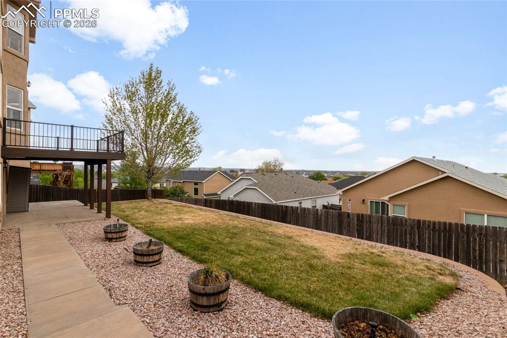 Image 34 of 35: Stucco exterior featuring stacked stone accents, a three-car garage, and a