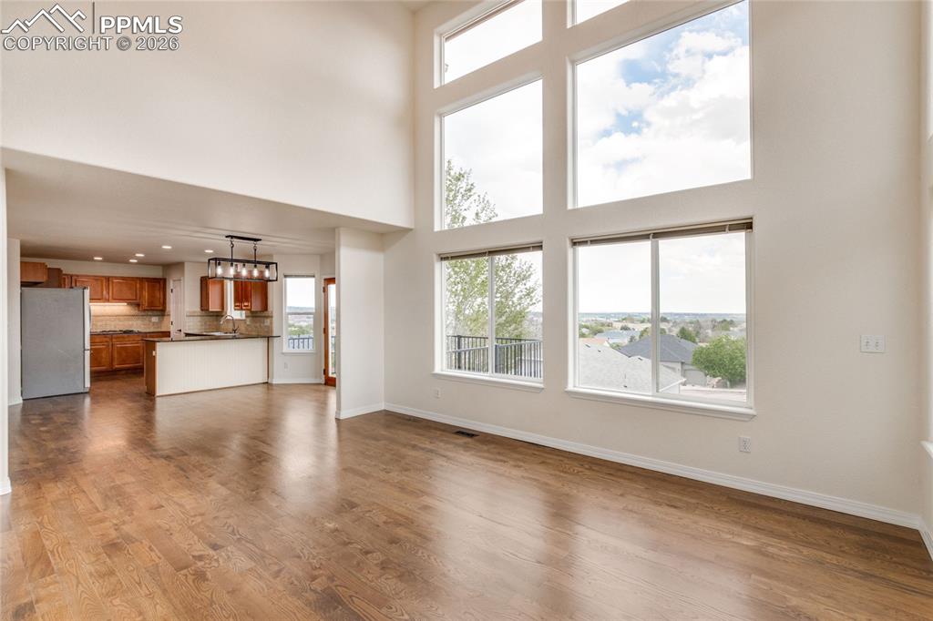 Image 4 of 35: Open concept family room, view to breakfast area, and kitchen.