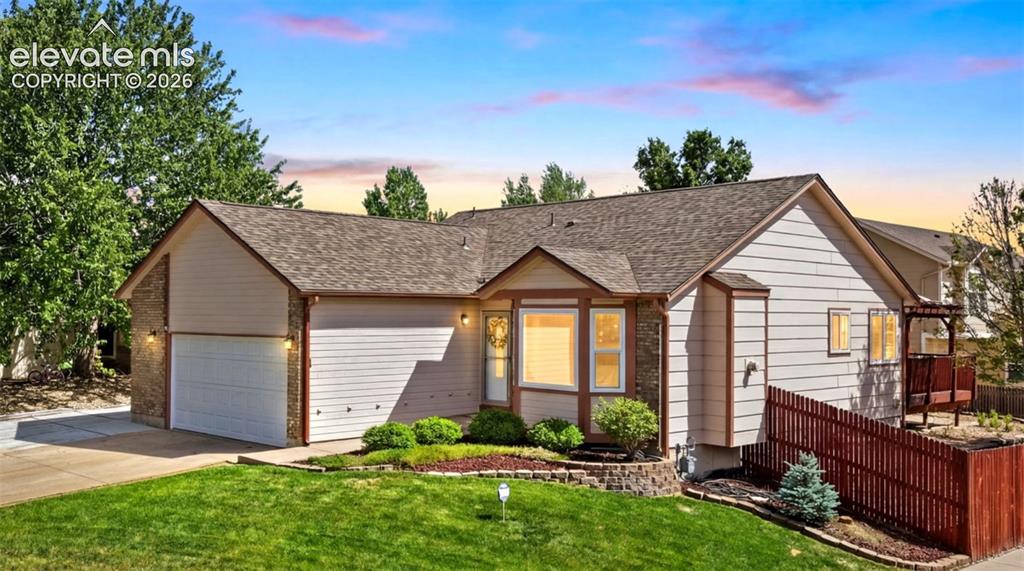 Image 1 of 32: Ranch-style exterior featuring a two-car garage, stone accents, and a bay w