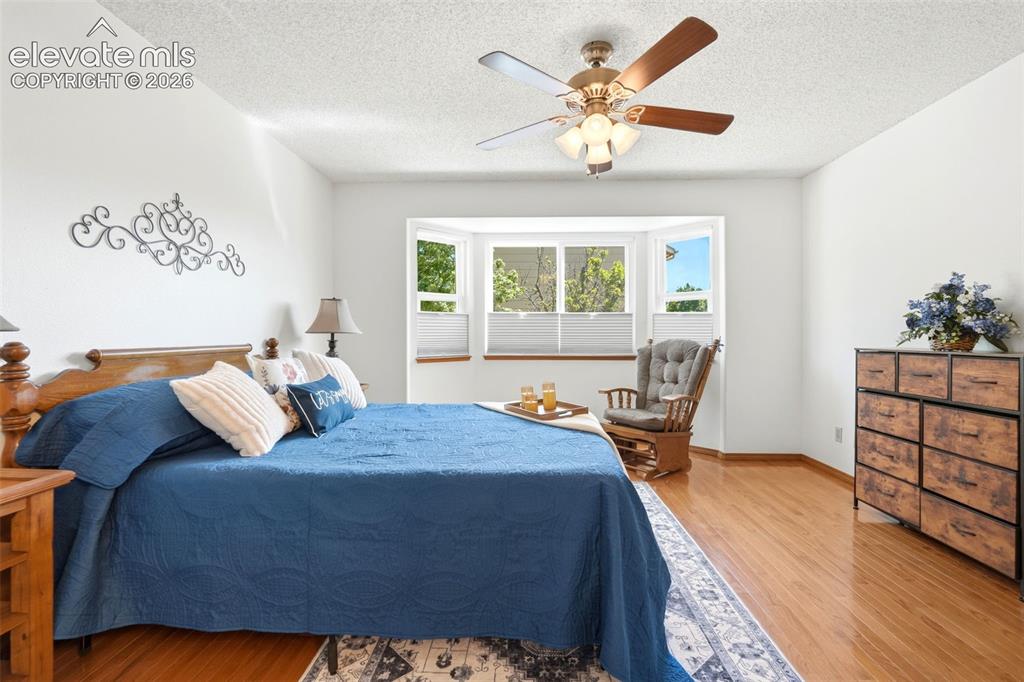 Image 12 of 32: Spacious interior featuring a bay window, wood-finish flooring, and a ceili