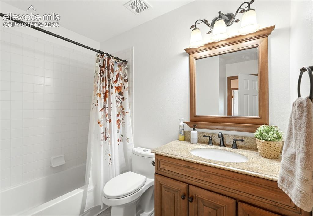 Image 16 of 32: Main level hall bathroom