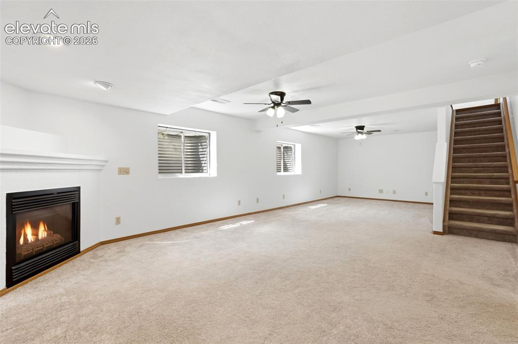 Image 21 of 32: Finish basement with fireplace