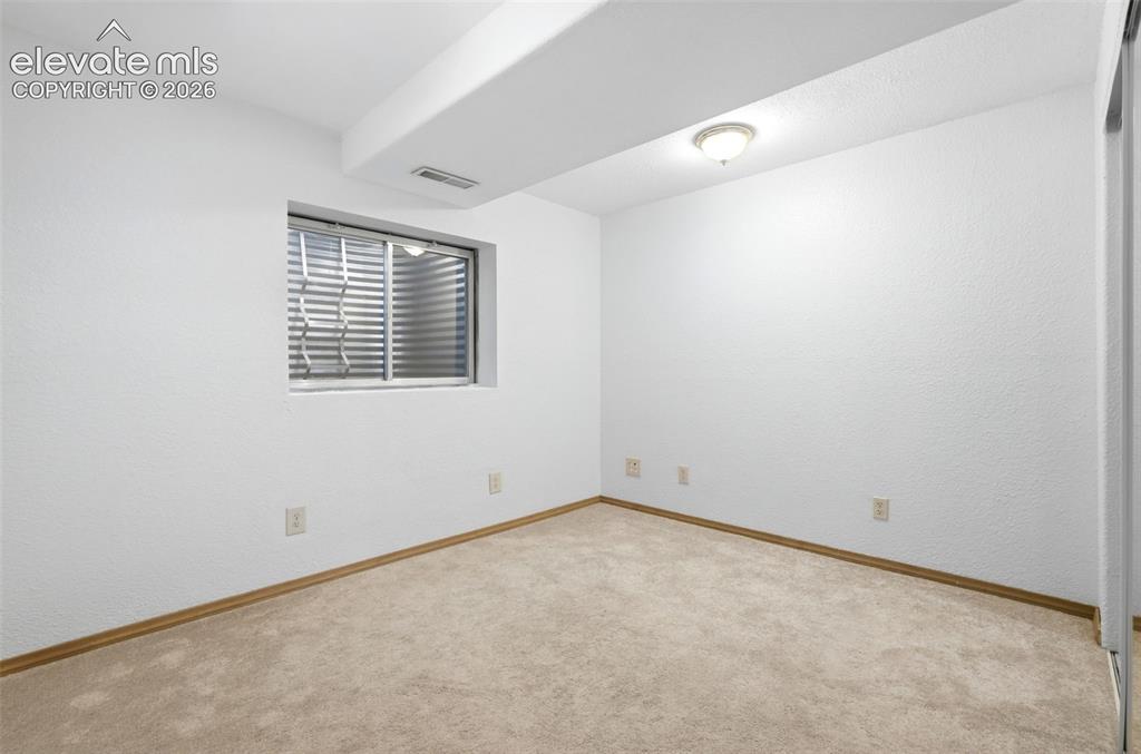Image 23 of 32: basement bedroom