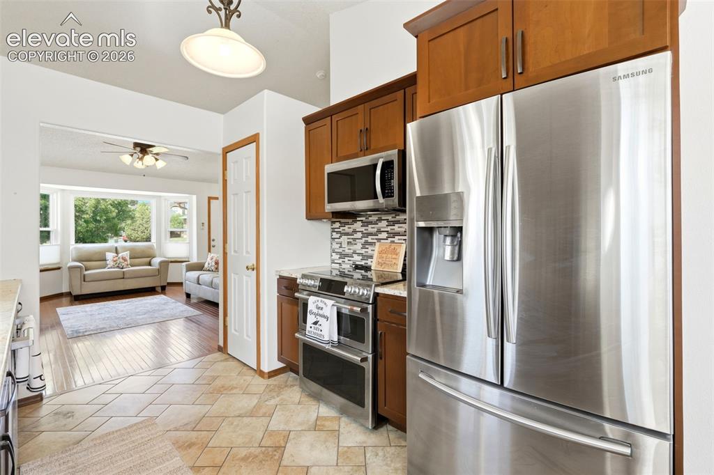 Image 9 of 32: Kitchen featuring tile flooring, stainless steel French door refrigerator,
