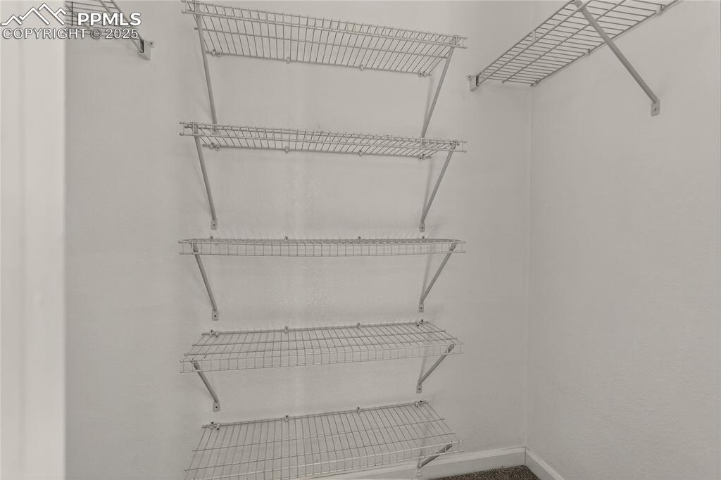 Image 16 of 25: Primary walk-in closet