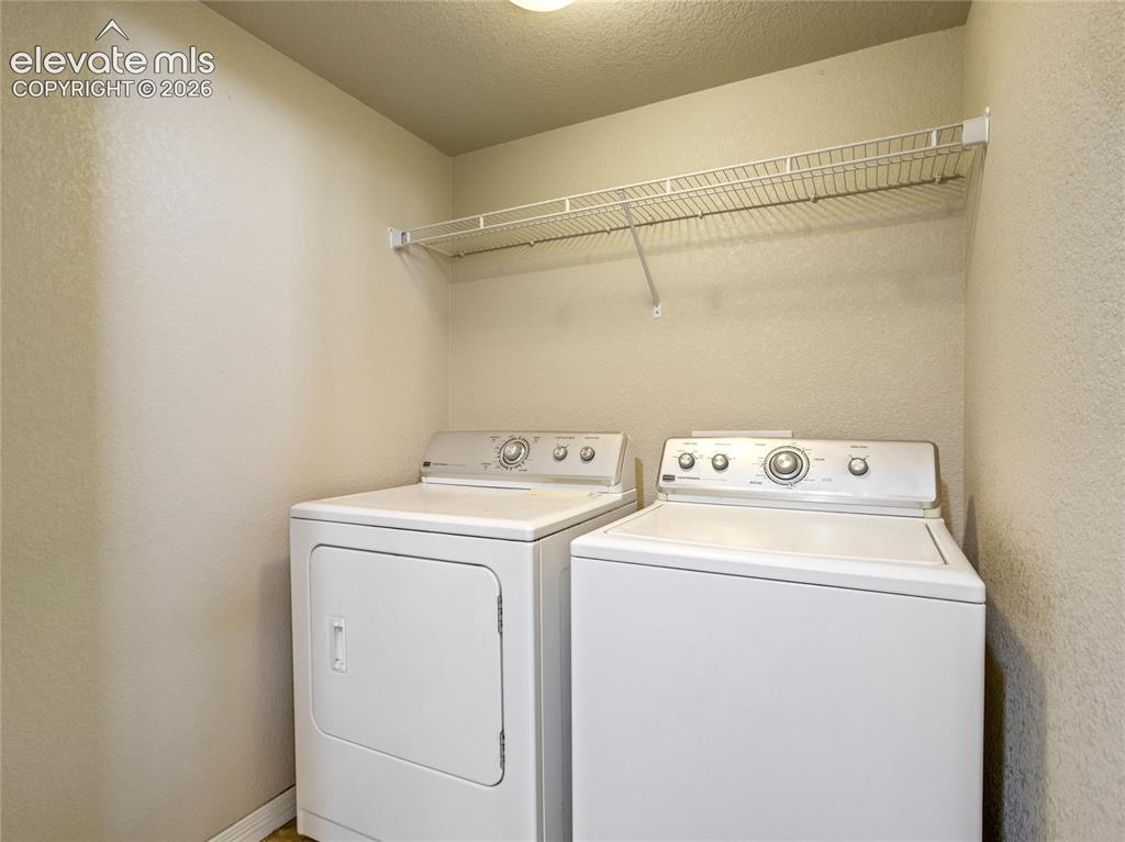 Image 19 of 39: Laundry room with overhead storage