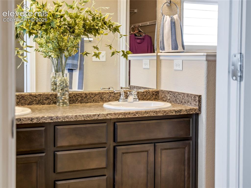 Image 23 of 39: Primary en-suite with spacious vanity and storage