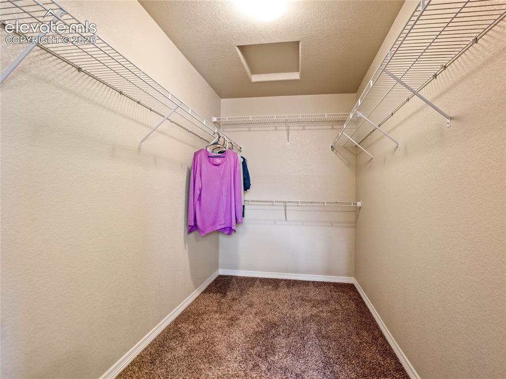 Image 27 of 39: Spacious walk-in closet in the primary bathroom