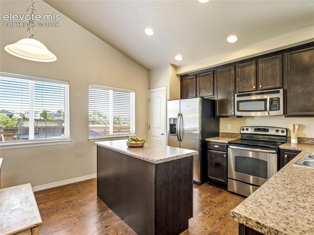 Image 3 of 39: Kitchen is open to the main level and walk-out level living spaces