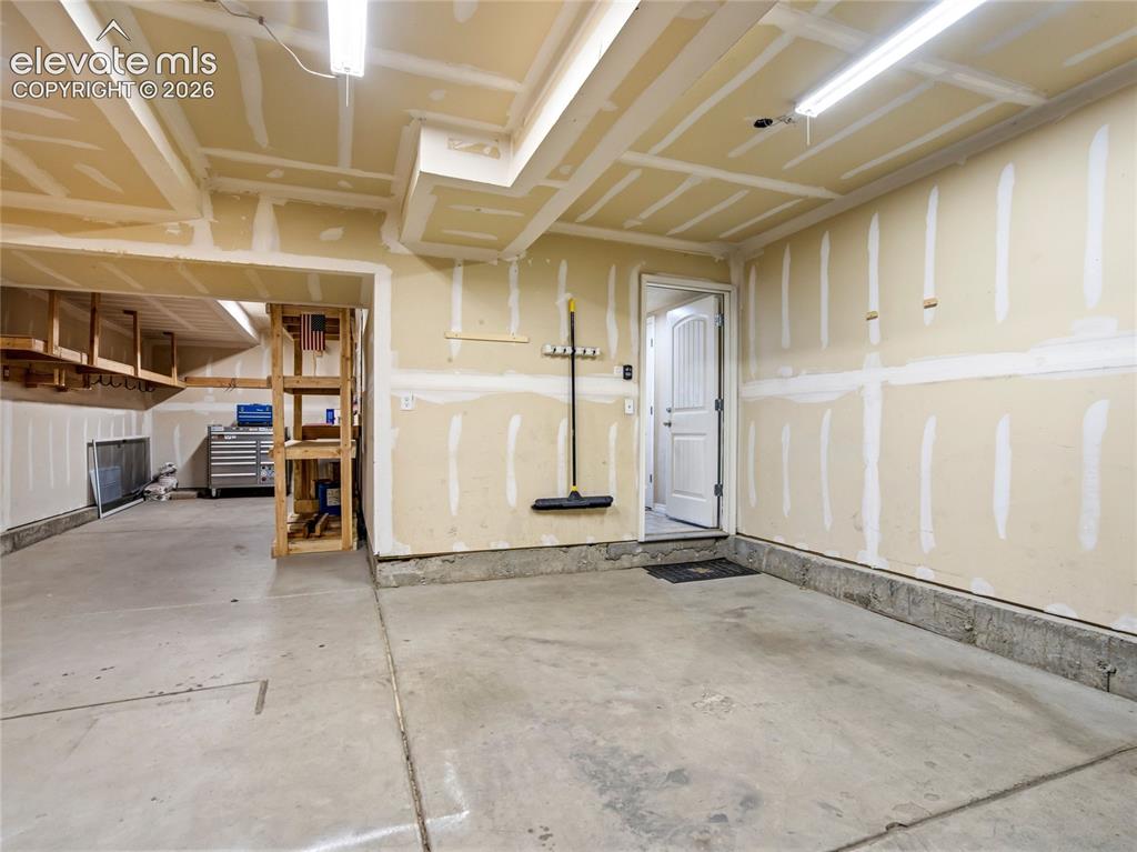 Image 33 of 39: The garage is versatile enough to have a workshop or tandem spaces