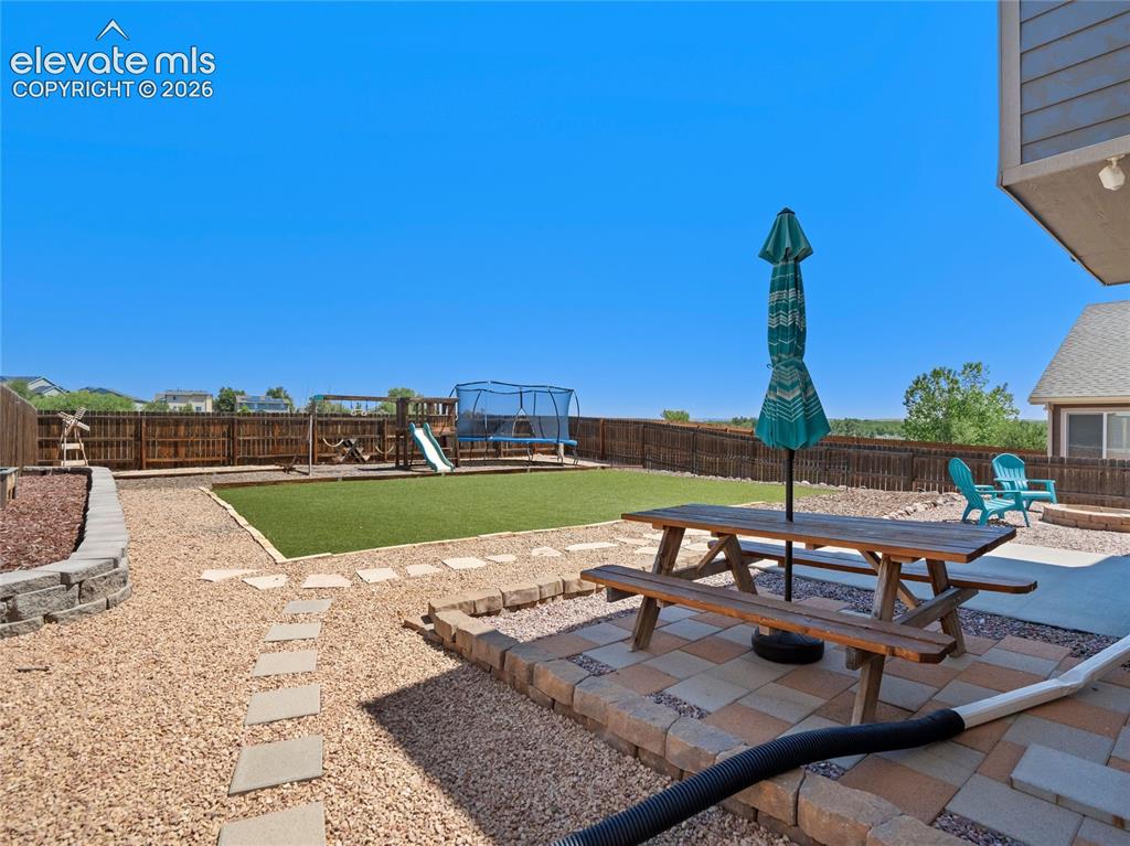 Image 34 of 39: Low-maintenance hardscaping in the backyard for year round enjoyment