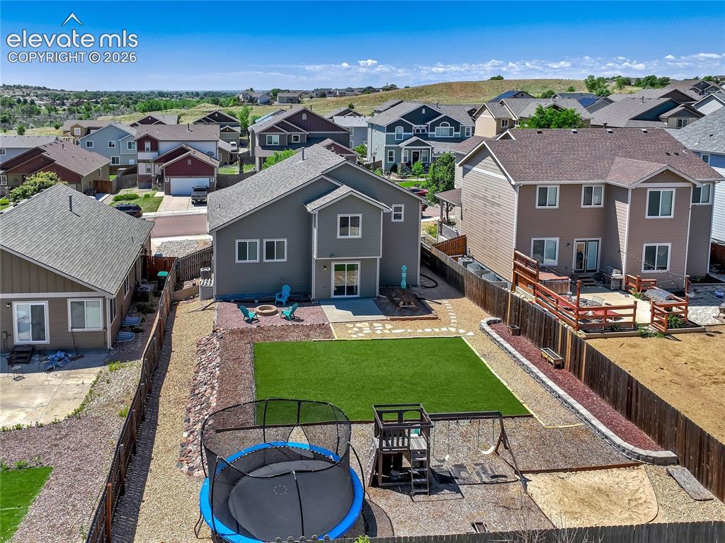 Image 6 of 39: This home has a large back yard with room for play or creating a garden of 