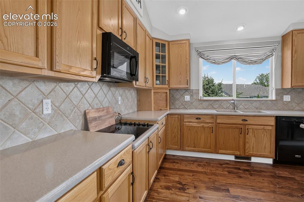 Image 15 of 49: Kitchen featuring light wood-finish cabinetry, light-toned countertops, a t