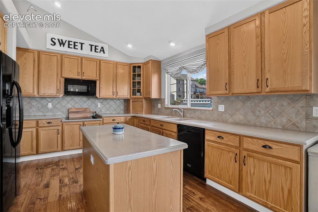 Image 18 of 49: Kitchen featuring wood-finish flooring, light wood cabinetry, light-toned c