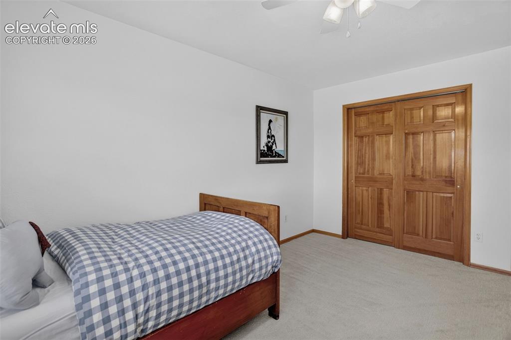 Image 35 of 49: Bedroom featuring light-colored carpeting and white walls