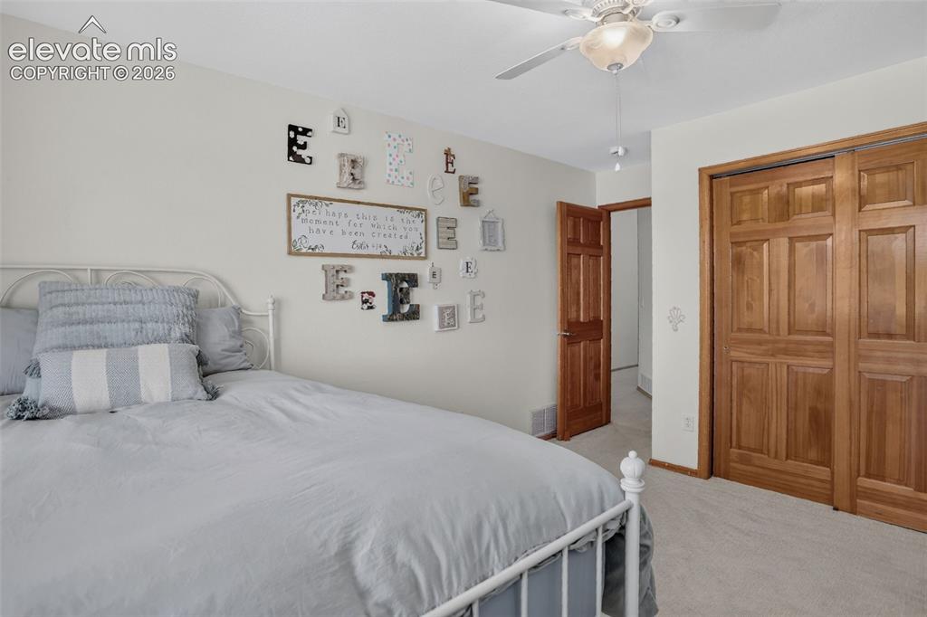Image 39 of 49: Bedroom featuring light wall color, a ceiling fan with integrated lighting,