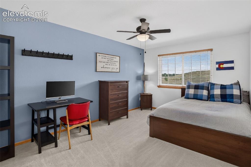 Image 40 of 49: Carpeted room featuring a single window with blinds, a ceiling fan with int