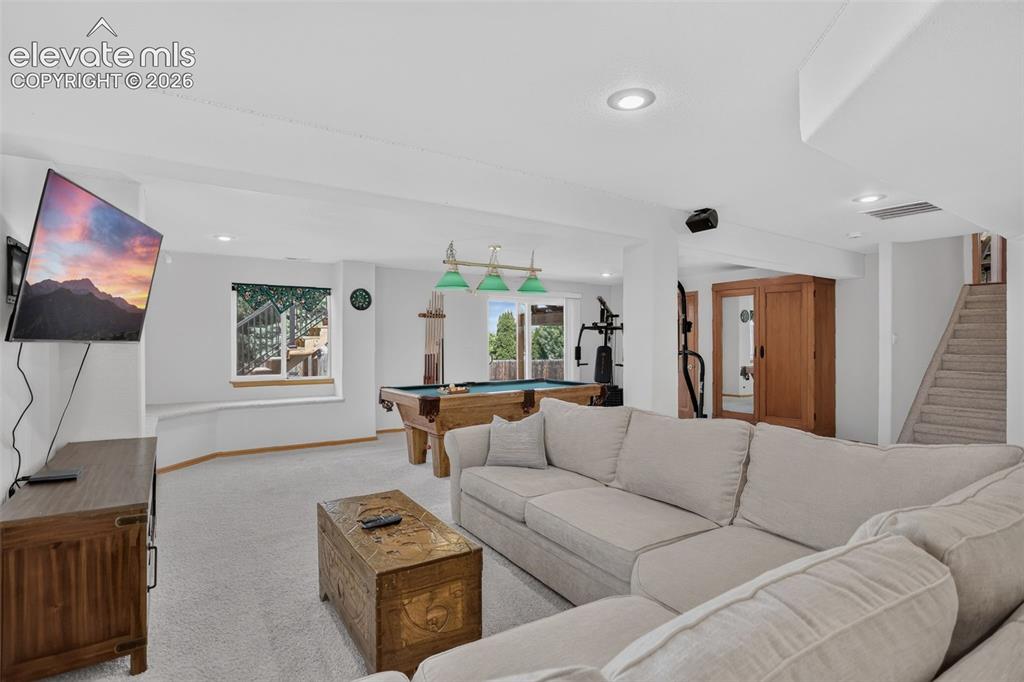 Image 41 of 49: Spacious recreational area featuring carpet flooring, recessed lighting, an