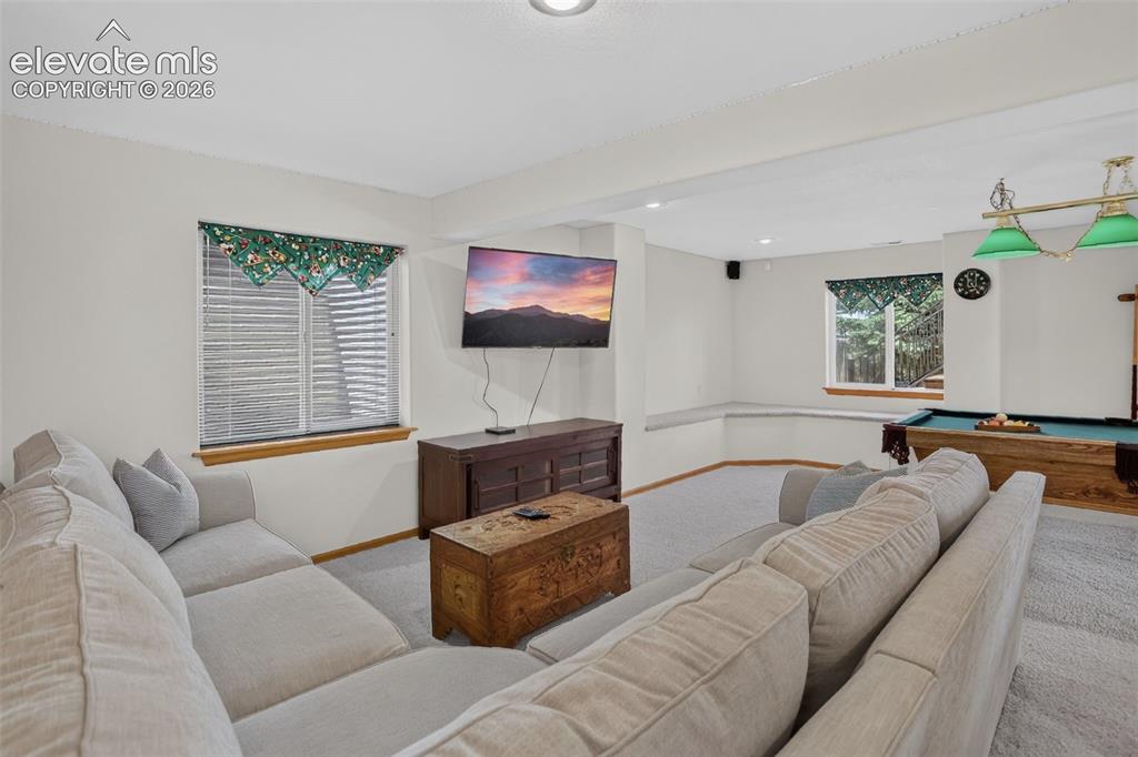 Image 42 of 49: Spacious recreational room featuring light-colored carpeting and recessed l