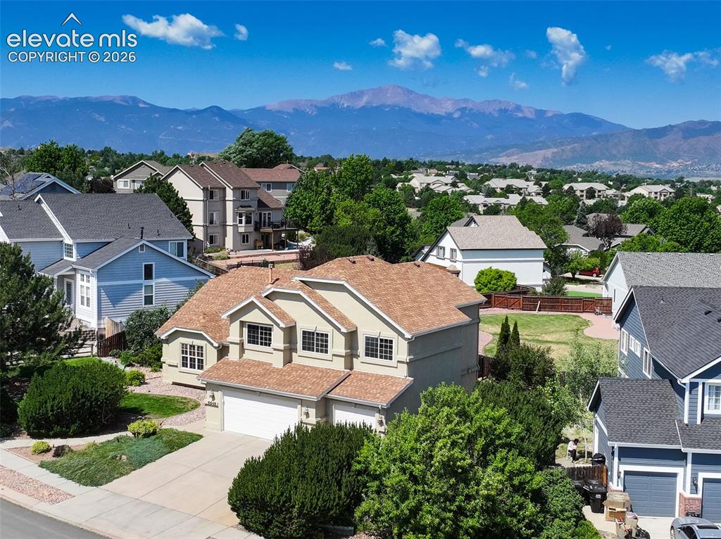 Image 46 of 49: Residential property featuring a tan exterior, attached two-car garage, and