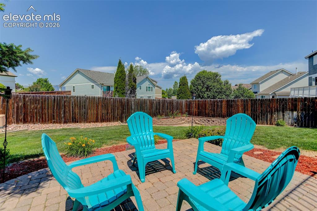 Image 6 of 49: Backyard patio featuring paver stone flooring, a surrounding wood privacy f