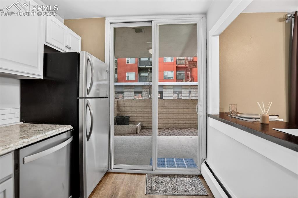 Image 12 of 26: Kitchen, sliding door to patio