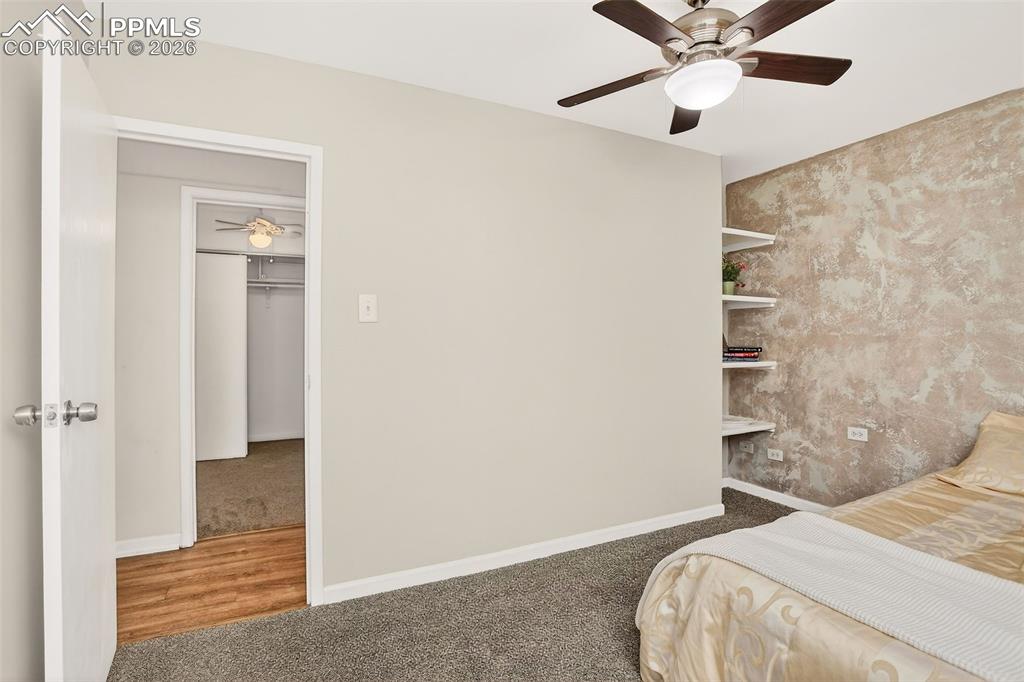 Image 14 of 26: Primary Bedroom. built in shelving, new carpet