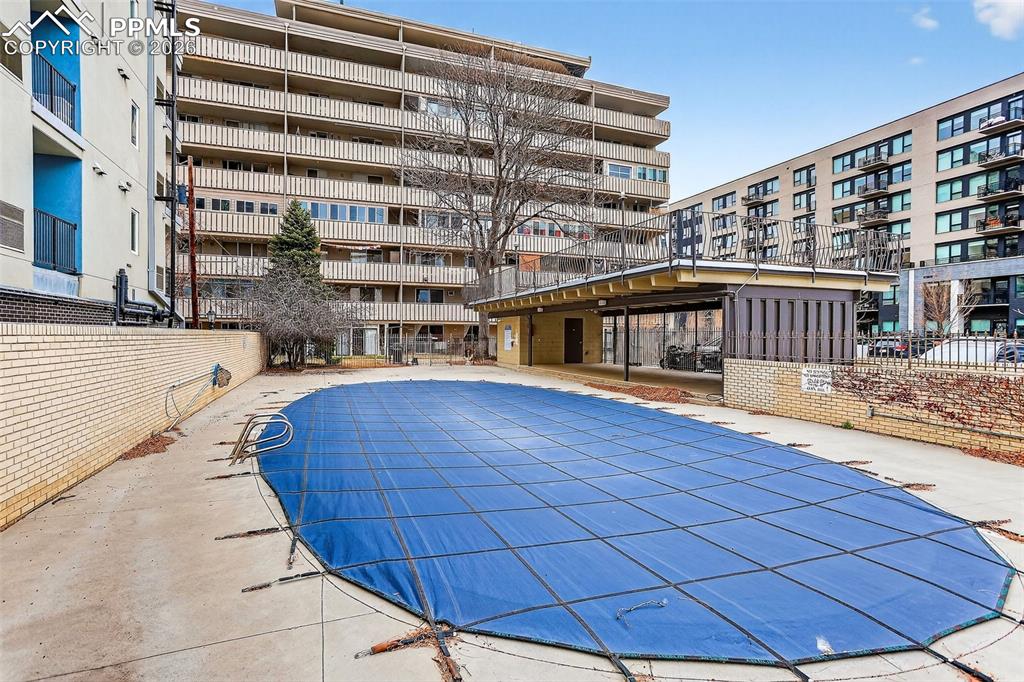 Image 3 of 26: View of pool and gated patio area, grills available