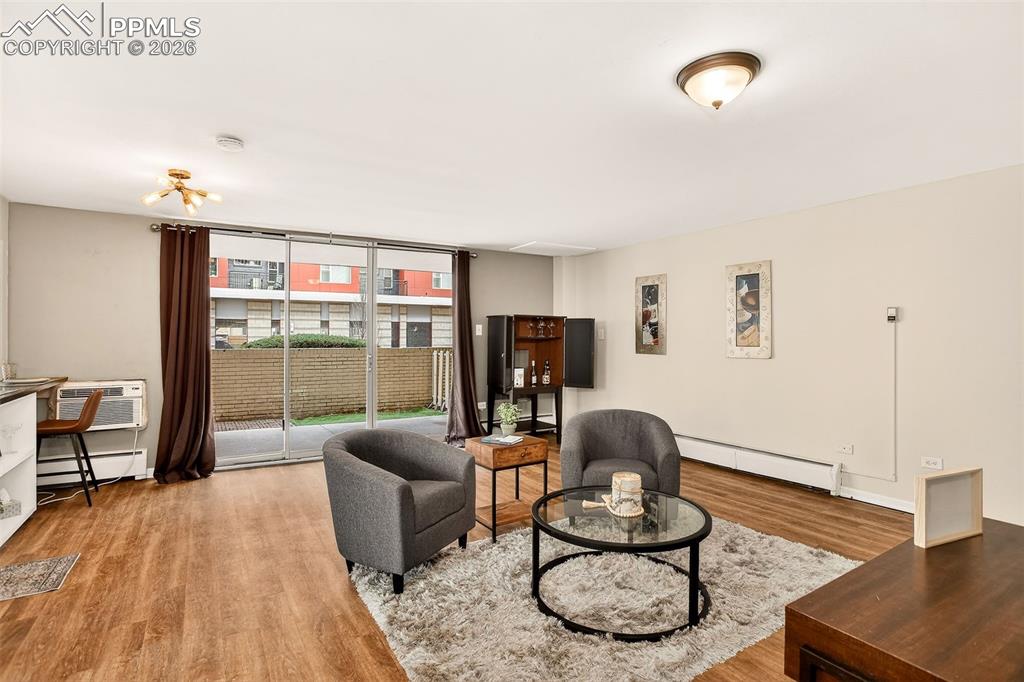 Image 6 of 26: Living area with large sliding door, lots of light