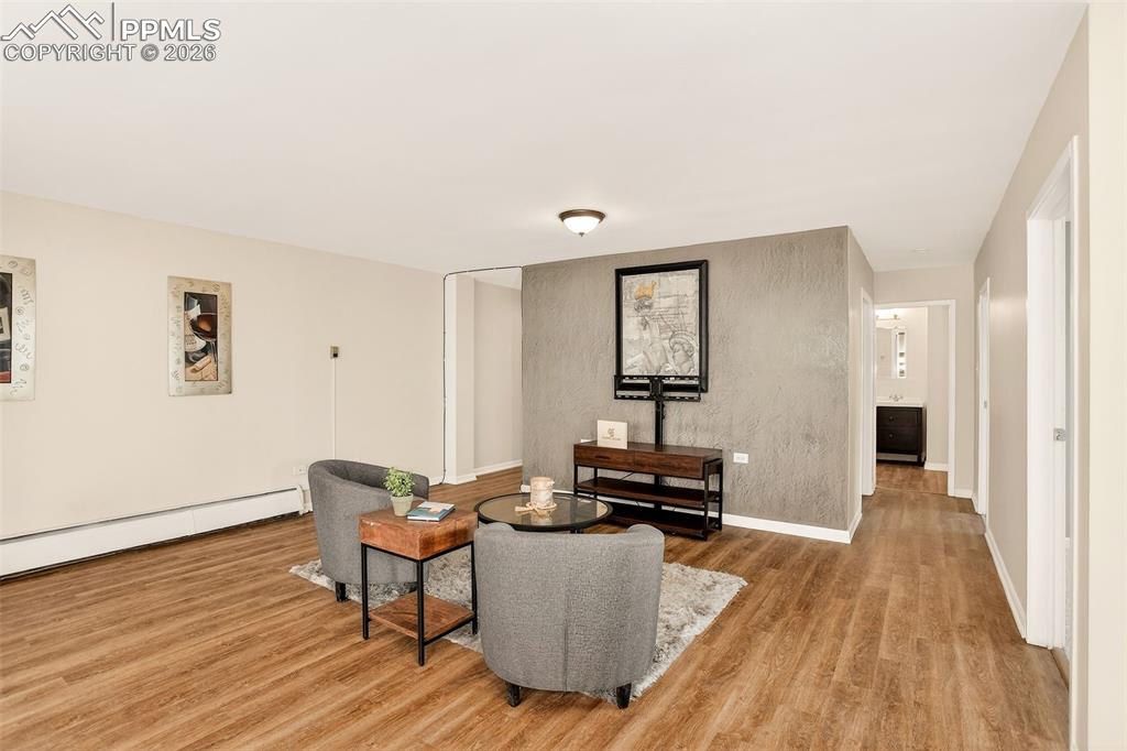 Image 8 of 26: Open concept living area, hall to front door, hall to bedrooms