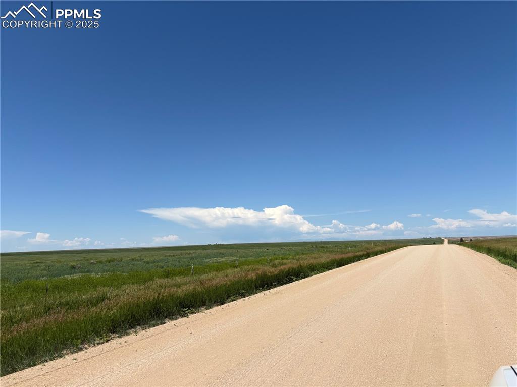 Image 5 of 7: View of dirt / gravel road with a view of countryside