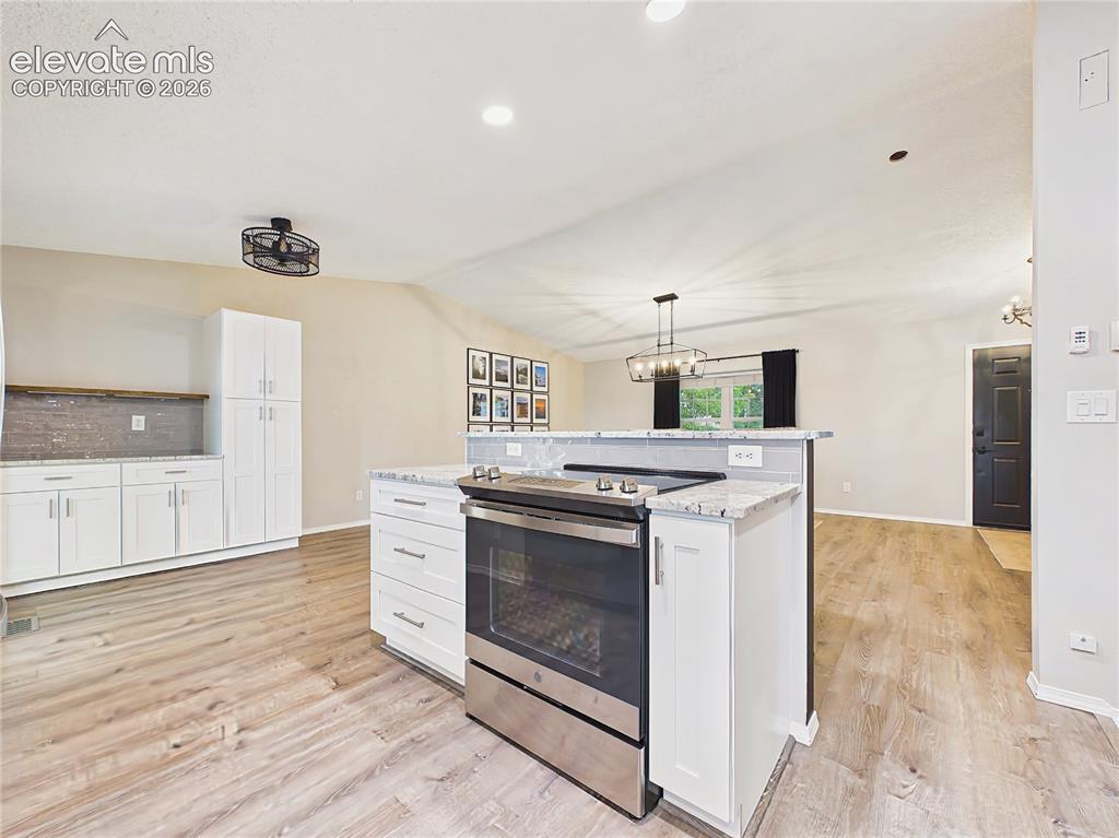 Image 11 of 50: Spacious center island with bar seating, additional prep space, and an open