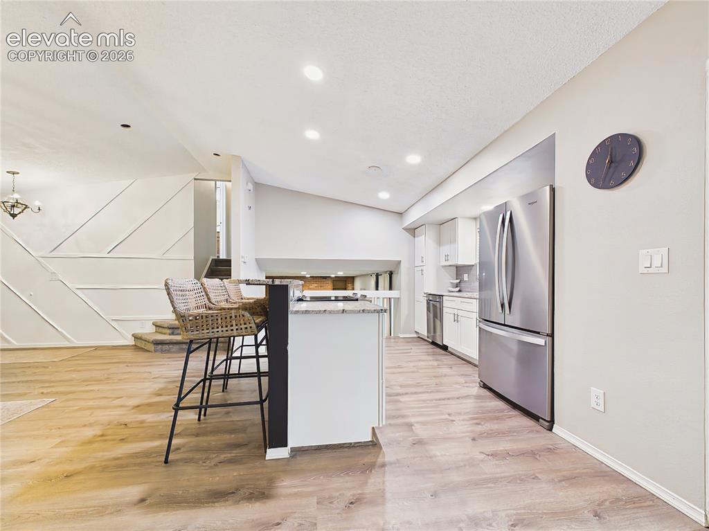 Image 15 of 50: Modern finishes, stainless steel appliances, recessed lighting, and an expa