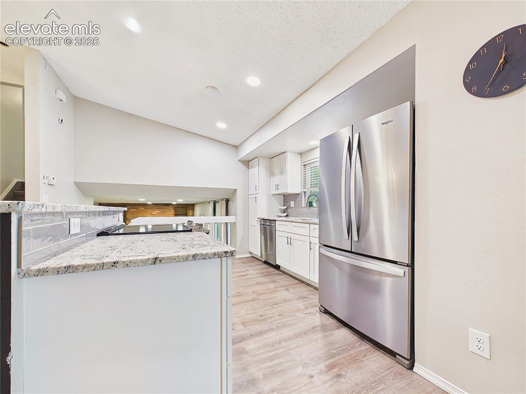 Image 17 of 50: Kitchen with Breakfast Bar – Large granite-topped breakfast bar offers comf