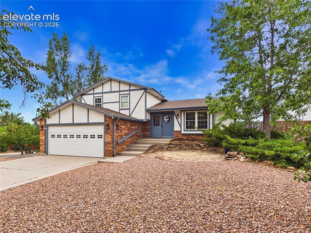Image 2 of 50: Inviting exterior showcasing established trees, low-maintenance landscaping