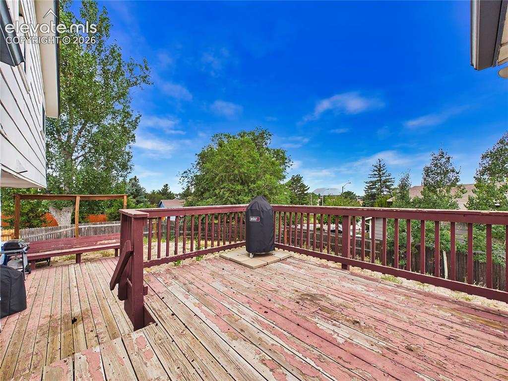 Image 22 of 50: Spacious wood deck with plenty of room for outdoor dining, grilling, and en