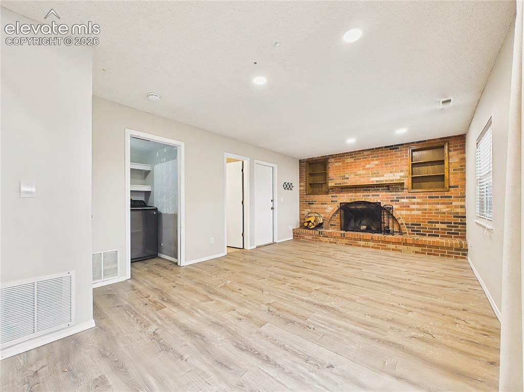 Image 24 of 50: Expansive lower-level living area with recessed lighting, abundant floor sp
