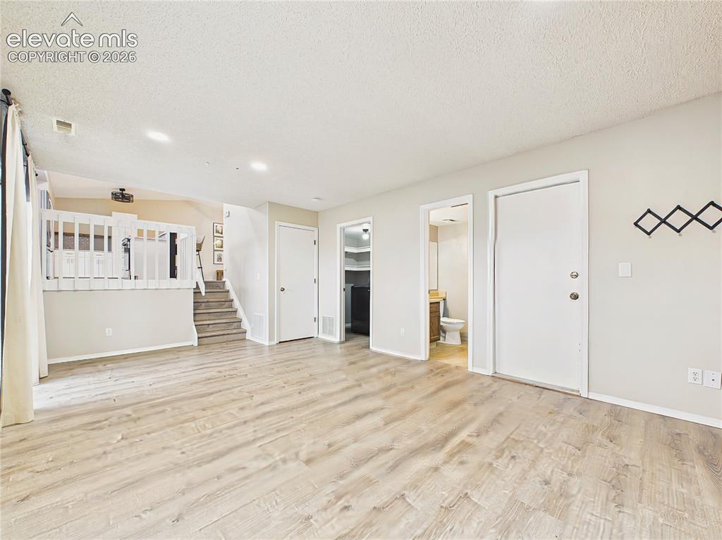 Image 26 of 50: Spacious family room with durable flooring and an open layout, offering fle