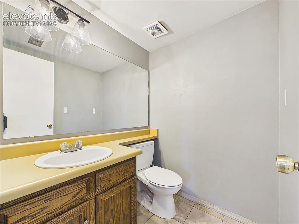 Image 27 of 50: Convenient lower-level half bath with an extended vanity, updated lighting,
