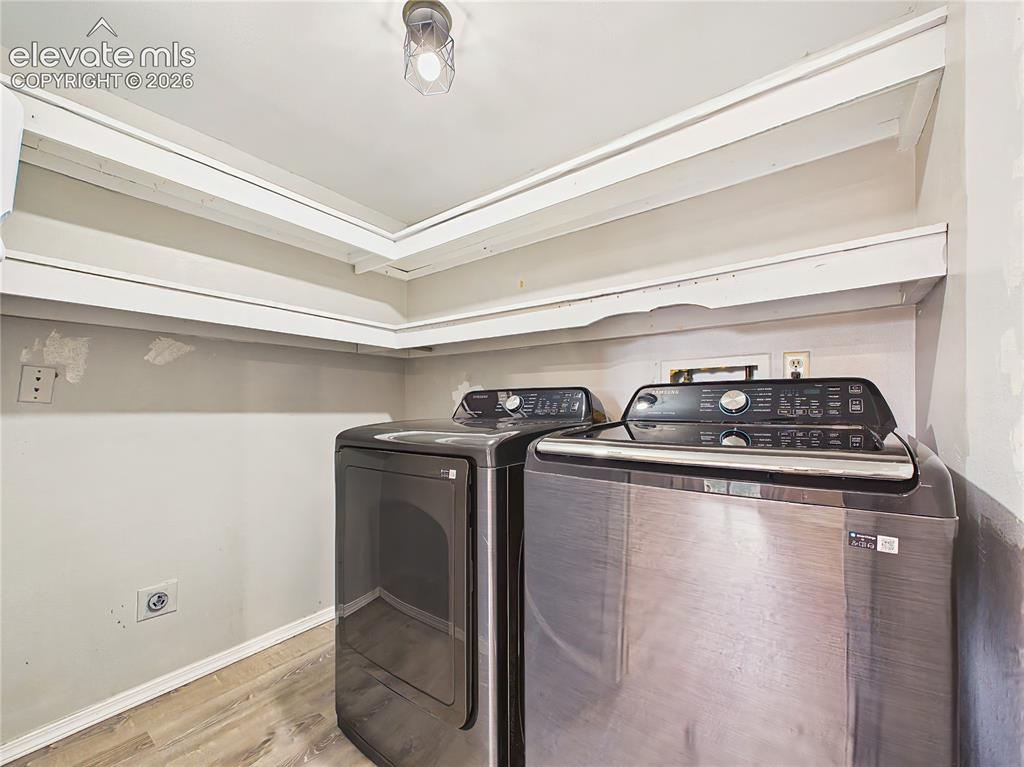 Image 28 of 50: Convenient laundry room with built-in shelving for organized storage and sp