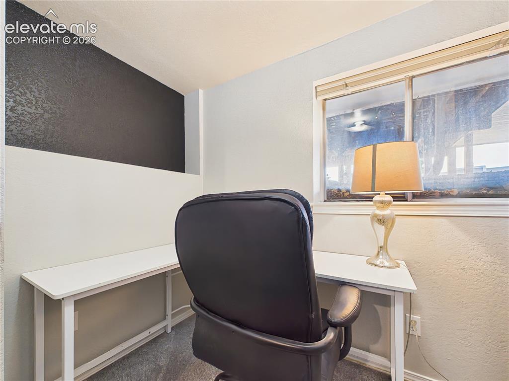 Image 29 of 50: Dedicated office nook with built-in desk space and a window for natural lig
