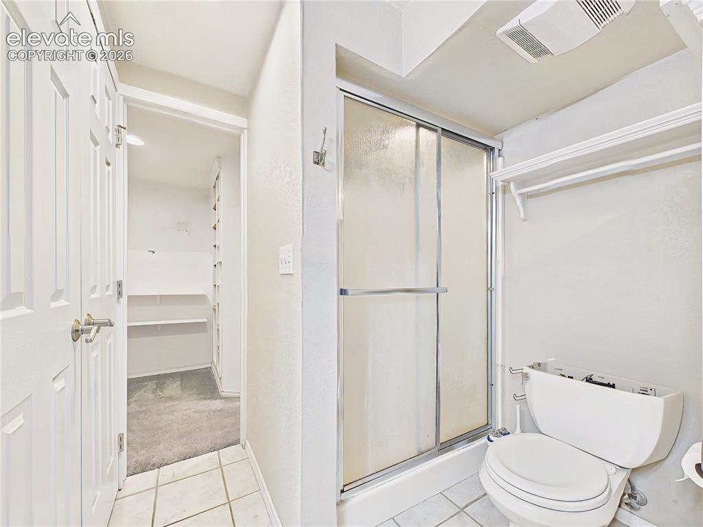 Image 34 of 50: Primary bath featuring a separate shower, private water closet, and conveni