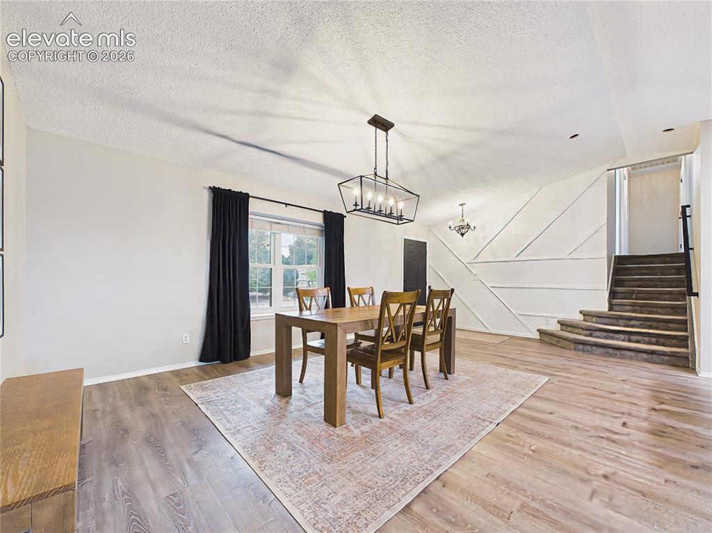 Image 7 of 50: Open dining space overlooking the beautifully updated kitchen with a large 