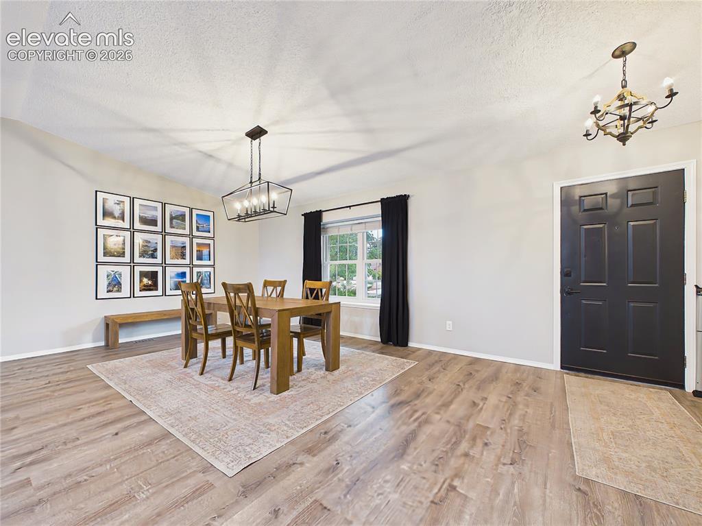 Image 8 of 50: Inviting dining room filled with natural light from a large picture window,