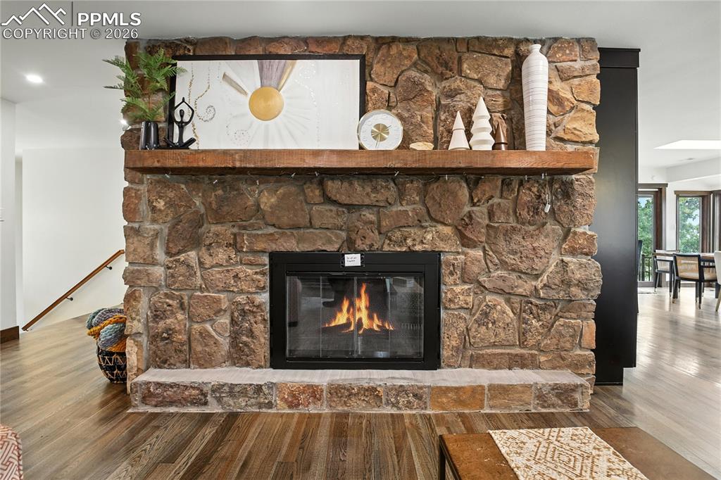 Image 23 of 50: Detailed view of wood finished floors and a stone fireplace