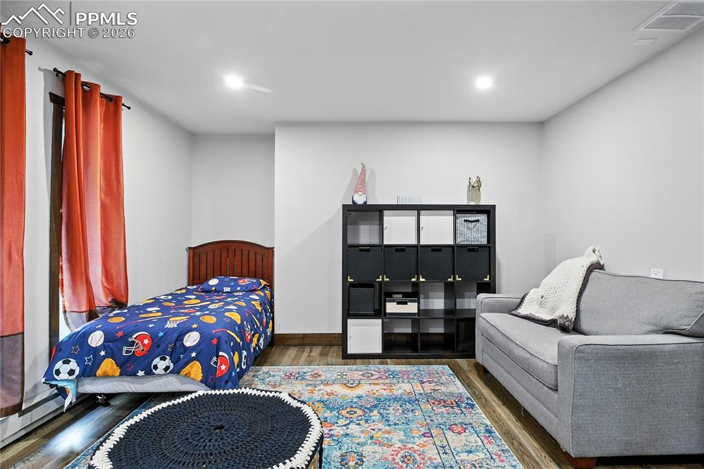 Image 33 of 50: Bedroom featuring wood finished floors and recessed lighting