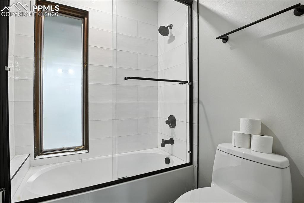 Image 37 of 50: Full bath with bath / shower combo with glass door and toilet